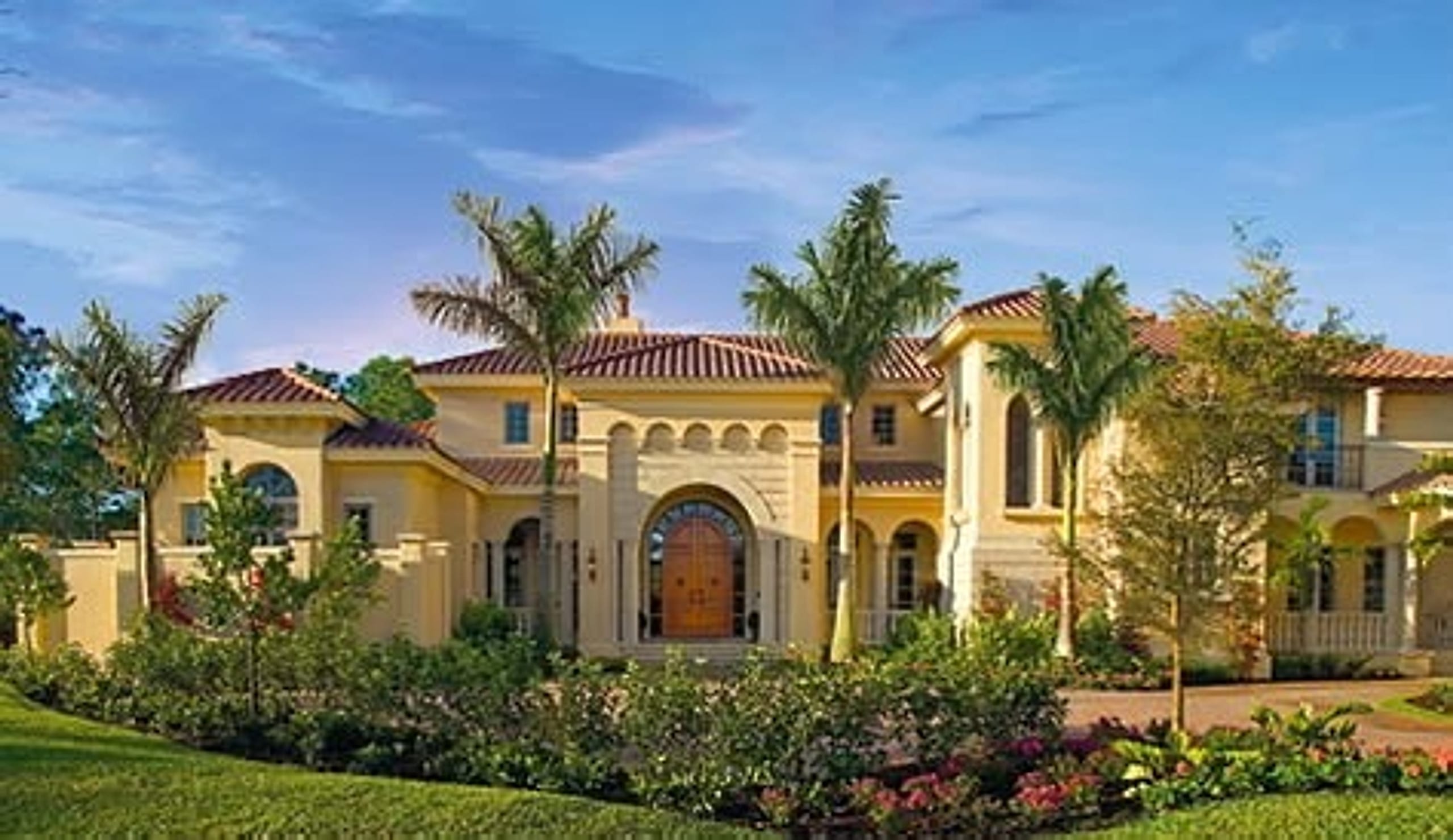 Luxurious Mediterranean villa estate with palm trees and landscaped grounds
